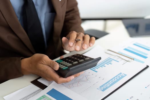 A businessman using a financial calculator to assess accounting data, highlighting the importance of precise financial reporting.