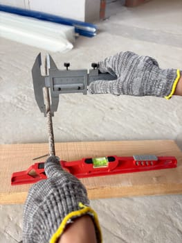 Metal caliper, construction and working measuring tool in the process of measuring the diameter of reinforcement. Measuring devices are used in construction.