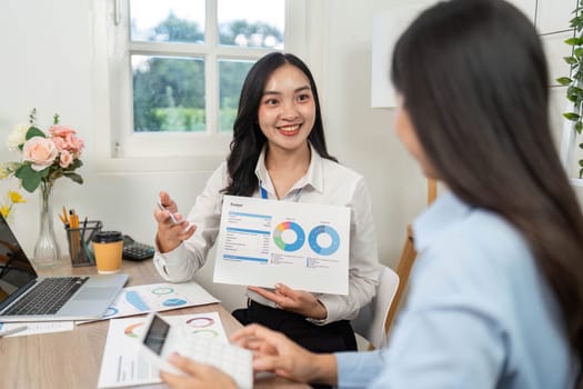 A business professional presenting budget analysis with charts, highlighting teamwork and effective communication.
