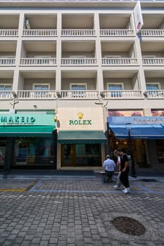 Rodas.Greece - june 04, 2025: Prominent Rolex boutique facade on a busy street in Rhodes, surrounded by other shops and urban architecture.