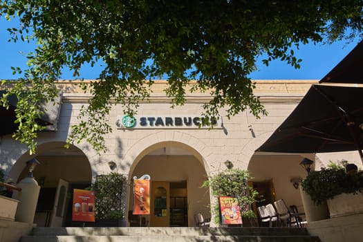 Rodas.Greece - june 04, 2025:  Exterior of a Starbucks coffee shop in Rhodes, featuring its iconic logo and architectural details under a clear blue sky.