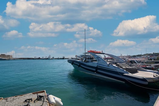 Rodas.Greece - june 04, 2025: Wide angle view of the lively Rhodes harbor, showcasing diverse maritime vessels and the beauty of the Aegean Sea.