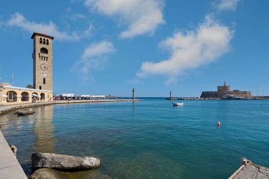 Rodas.Greece - june 04, 2025: Scenic view of Rhodes' waterfront, featuring its historic clock tower, a symbol of the island's rich heritage and charm.