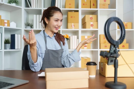 An entrepreneur enthusiastically engages with her audience during a live-stream, showcasing products from her small business.