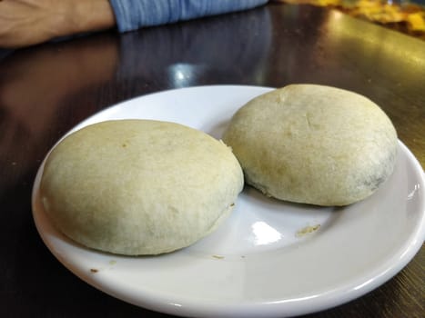 Freshly Served Izmir Bomb Kurabiye on a Plate in a Cozy Cafe Setting