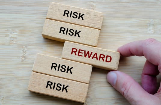 Risk and Reward text, depicting the classic decision making dilemma of weighing risk against reward in any venture.