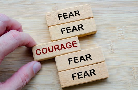 Fear and Courage in Contrast, a visual metaphor showing the inner conflict between fear and courage using wooden blocks.