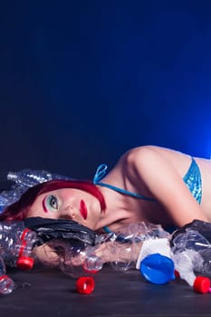 Ocean plastic pollution. Cute mermaid swimming in water with plastic garbage. Stop plastic pollution. Fairy tale and reality concept