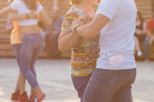 Kizomba, bachata or salsa concept - beauty couple dancing social dance on open air party