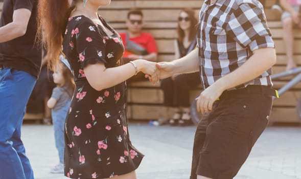 Kizomba, bachata or salsa concept - beauty couple dancing social dance on open air party