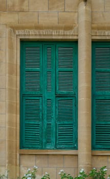 Old Stone Building with Green Shutters on Windows in Cyprus