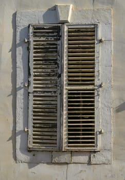 White Window with Wooden Shutters on Traditional Cyprus House