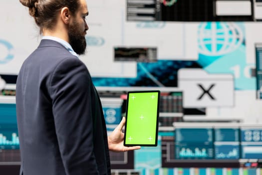 Male administrator using chroma key display for a digital analysis, ensures financial planning and business success with digital growth driven tools and monthly reports. Insightfulness.