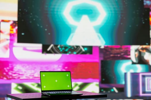 Laptop running isolated mockup screen surrounded by funky visual art clips, glowing in the dark and creating a clubbing atmosphere. Nightlife ambiance with modern beats and lights.