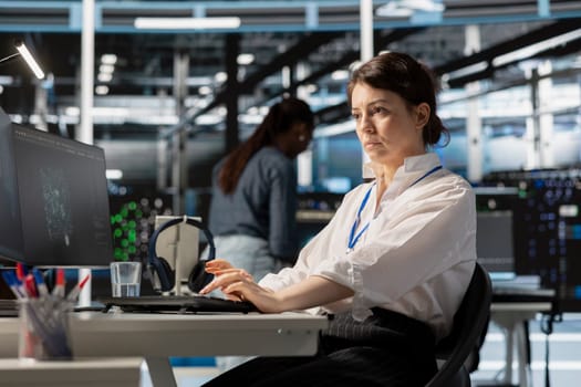 Data center computer scientist uses PC to update servers tech, configuring gear using software. Server hub IT professional reviewing hardware analytics, ensuring reliable network operations