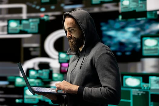 Skilled IT expert compromising cyber security through malware and viruses, digital threat of hacking with unauthorized intrusion into secure networks. Leading to quantum threat and risk.