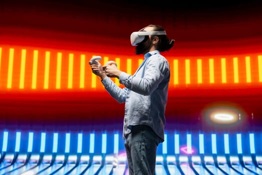 Modern man in a neon lit night scene using vr high tech glasses, embodying cyberpunk style and digital inspiration through artistic vision. Glowing reflections of futuristic aesthetics.
