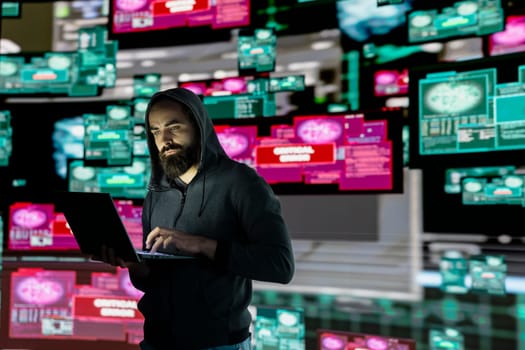 Male hacker operates in stealth mode breaching system access through coding, bypassing firewalls and exploiting vulnerabilities in network security to carry out cyber crime and data infiltration.