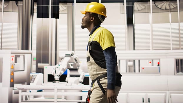 Technician holding toolbox walking in factory, overseeing solar panel production lines equipment. Engineering expert maintaining photovoltaic assembly systems in automated industrial plant, camera A