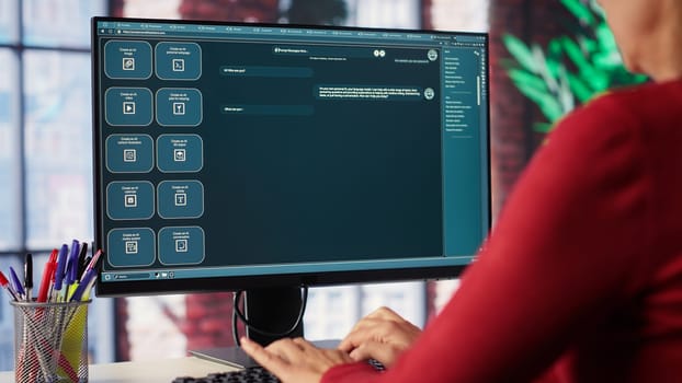 Professional person engaging with an AI chatbot on a computer screen, exploring power of digital assistance through artificial intelligence. Solutions for assistance at desktop. Camera A.