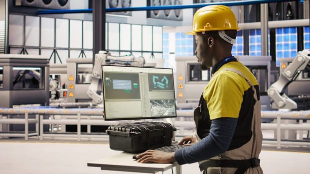 Engineer overseeing solar panel production lines equipment using PC software. Worker maintaining photovoltaic assembly systems in automated industry 4.0 factory using computer, camera A