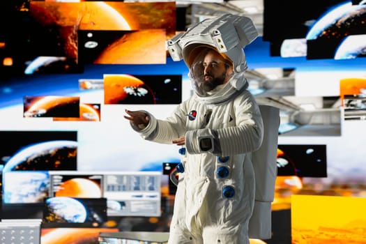 Young male cosmonaut drifting in zero gravity during a space walk, reflecting interstellar adventure, celestial wonder and the future of astronautics and planetary discovery. Space craft.