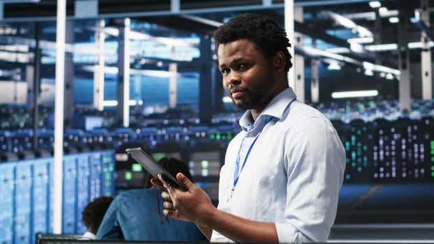 Data center technician uses node tree programming interface to identify equipment performance issues. Engineer reviews data analysis graph in server hub to minimize hardware failures, camera B