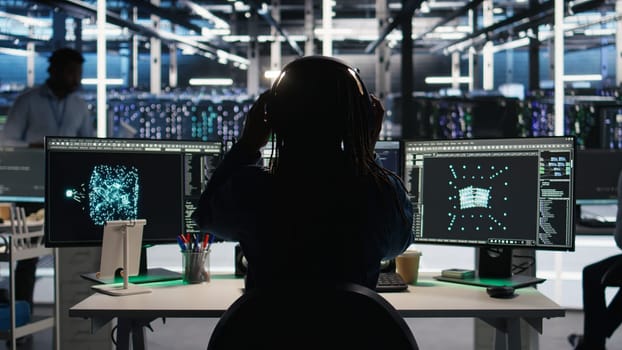 Data center engineer implements AI virtualization frameworks to optimize server clusters. Server hub IT professional doing artificial intelligence predictive analysis, camera A