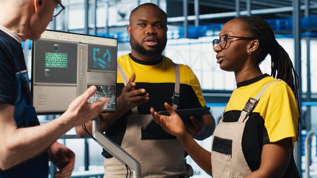 Photovoltaics smart factory team leader and workers talk about new PV materials. Industry 4.0 solar panels plant senior engineer and colleagues develop green energy systems prototypes, camera A