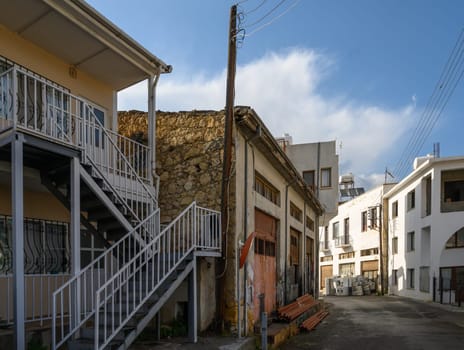 Charming narrow street in Lefke, Cyprus, lined with traditional white houses and historic details reflecting local architecture.