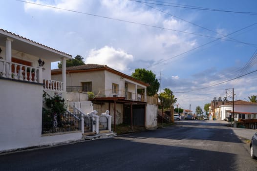 A quiet, authentic street in Lefke, Cyprus, with whitewashed buildings, charming architecture, and mountain views.