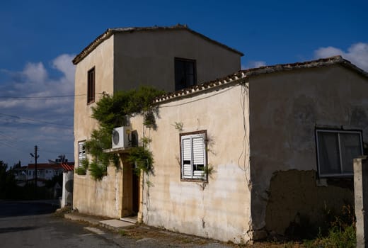 Picturesque narrow street in Lefke, lined with stone houses and aged wooden doors, typical of Cyprus.