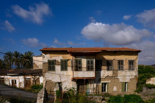 Quiet narrow street in Lefke, Cyprus, with white walls, arched doors, and rustic charm.