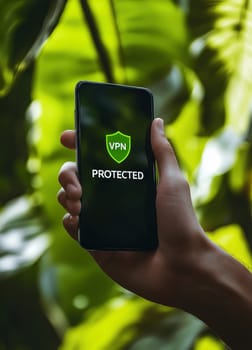male hand holding phone with app vpn protected on the screen..