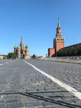 Moscow, Russia - May 28, 2025. Red Square in Moscow with a view of Saint Basil's Cathedral and the Kremlin's Spasskaya Tower under a blue sky. Made on smartphone.