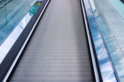 This is a closeup view of an escalator that is moving both up and down, showcasing its intricate design and functionality