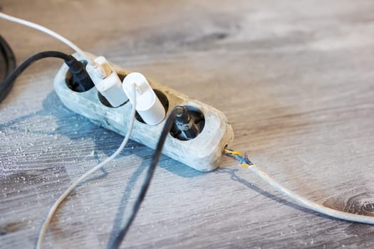 A collection of various electrical wires is connected to a power strip, allowing them to be powered simultaneously and efficiently
