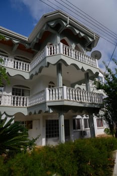Old Cypriot house with natural stone walls, green wooden shutters, and peaceful street atmosphere in Lefke.