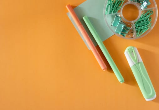 Top-down view of cool school materials, such as pencils and markeres arranged on a vibrant background. Perfect for educational, e-learning or academic themed visual materials. No people, modern aesthetic. copy space
