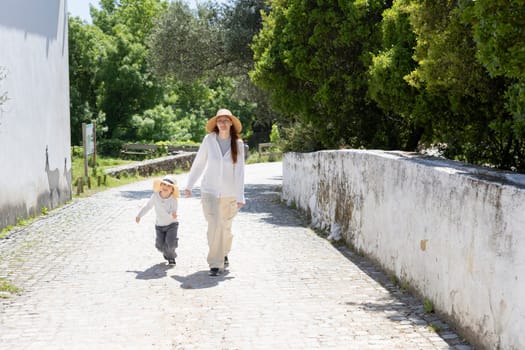 Mother and son enjoying a leisurely walk on a sunny day in the countryside