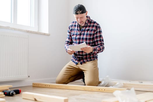 Craftsman Assembling Furniture On The Floor In A Bright Room