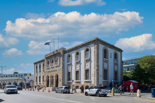Rodas.Greece - june 05, 2025: Exterior view of the Bank of Greece, a prominent building in Rhodes city, showcasing its classical design and the daily hustle of the street.