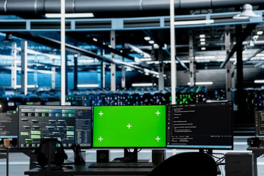 Mockup computers in data center facility used for managing supercomputers hardware energy consumption. Green screen PCs used for automation and monitoring processes in server farm