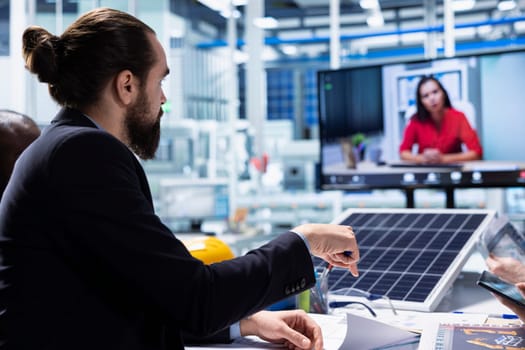Photovoltaics factory team in teleconference meeting improving development efficiency. Solar panels plant researchers in office studying how to harness sun power during online videocall