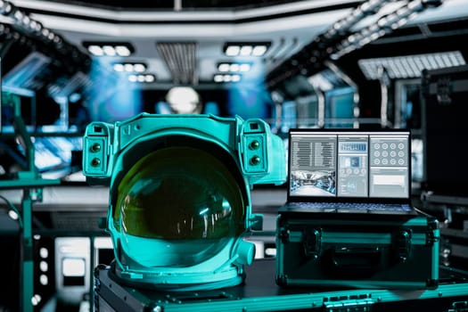 Close up of space helmet next to laptop running ship systems interface inside futuristic spacecraft. Notebook dashboard readouts metrics and astronauts equipment prepared for flight