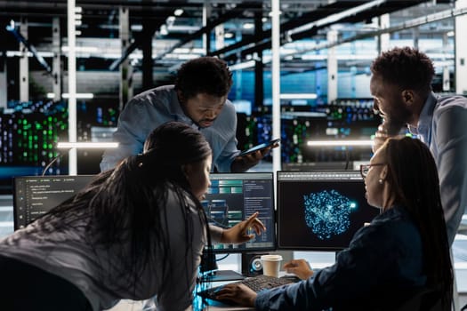 Data center engineering team implements AI virtualization frameworks to optimize server clusters. Teamworking server hub colleagues do artificial intelligence predictive analysis
