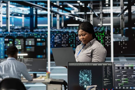 Data center engineer leverages artificial intelligence visualization tools to identify real time performance anomalies within server clusters and network segments, configuring hardware