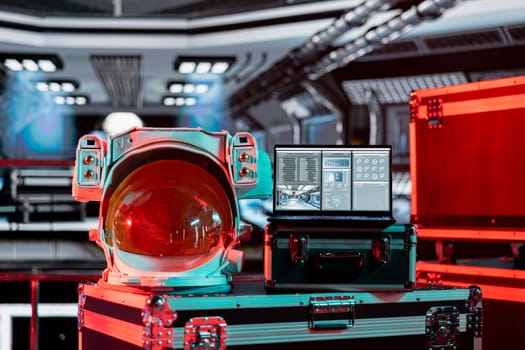 Red light in spacecraft over space helmet and laptop showing errors during orbit launch systems verification. Malfunction indicator blinking in spaceship during galaxy flight