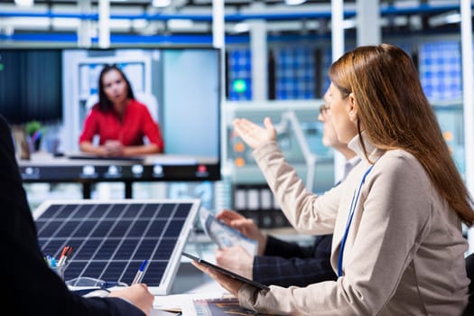 Investors evaluating photovoltaics factory production efficiency during online videocall before investing. Shareholders doing teleconference meeting with managers to ask technical questions