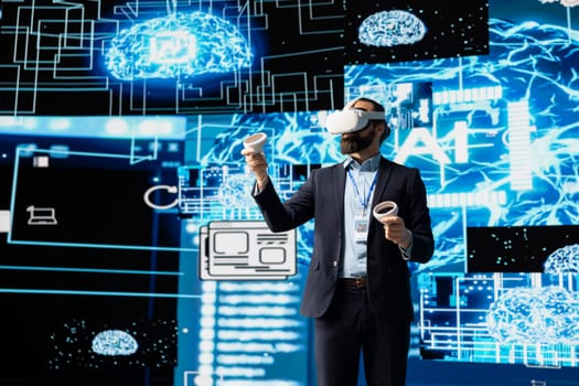 Modern businessman uses virtual reality gadget next to neural network system, using cybernetics and robotics for deep learning concept. Using AI brain automation tools for development.